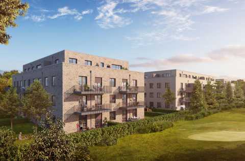 Moderne Wohngebäude mit Balkonen, umgeben von Grünflächen und Bäumen