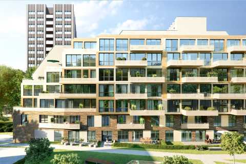 Modernes Wohnhaus mit vielen Balkonen, im Hintergrund ein Hochhaus und Bäume.