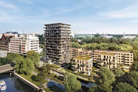 Mehrstöckiges Wohnhaus mit umliegenden Gebäuden und viel Grün in der Stadt.