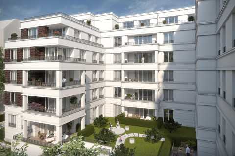 Innenhof eines modernen weißen Wohngebäudes mit Balkonen und Grünanlagen.