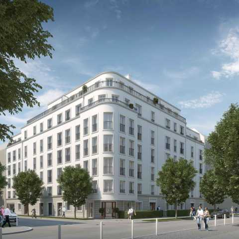 Modernes weißes Wohngebäude an einer Straße mit Bäumen und Passanten.