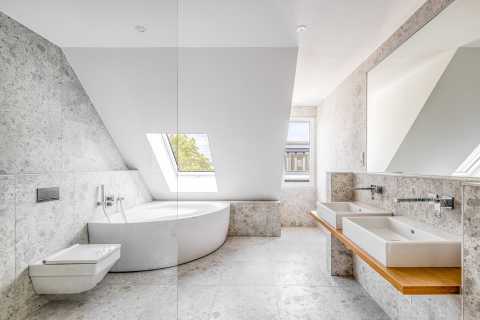 Modernes Bad mit Eckbadewanne, Doppelwaschbecken und großem Fenster.